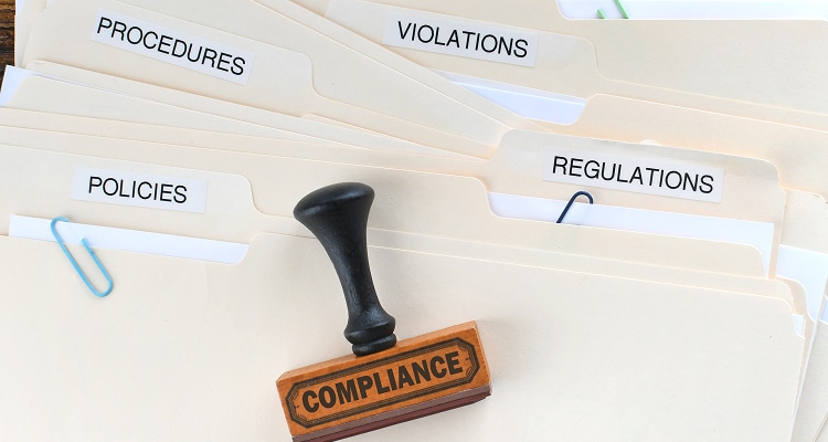 compliance rubber stamp on folders marked policies original